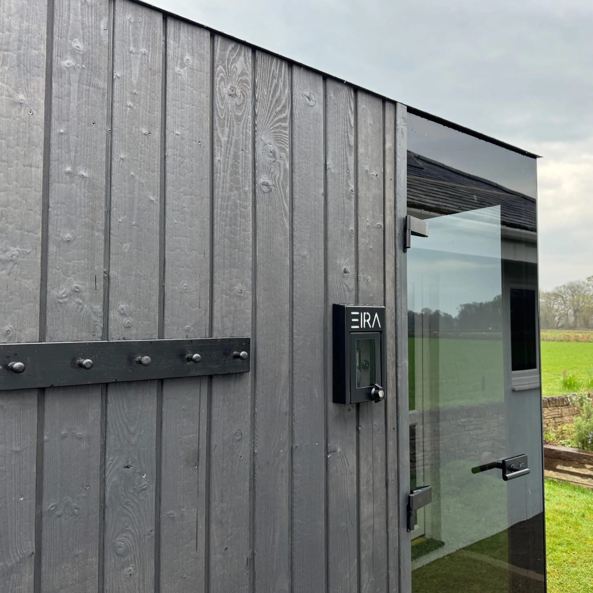 Side view of the Signature Sauna. Includes the robe hooks, glass door, stainless steel hinges and the weatherproof EIRA control housing.